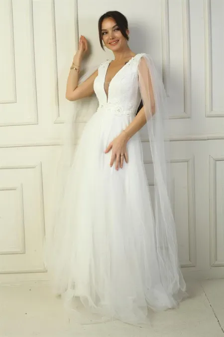 Robe de soirée longue en tulle pour femme, décolleté en V devant et dos, ornée de perles et à taille large.