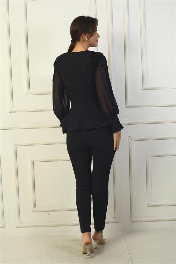 Two-piece set with chiffon sleeves and beaded shoulders.