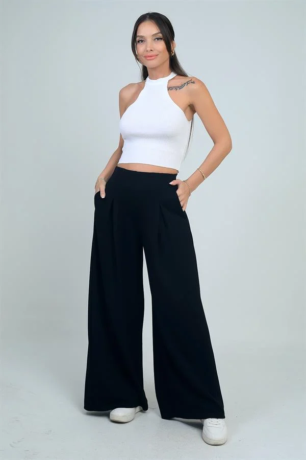 Pantalon Osyho pour femme, jambes larges, taille élastique, poches et plis sur le devant.