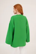 Tunique verte en gros avec détail de cravate sur le devant et manches espagnoles