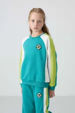 Ensemble de survêtement Tommylife Wholesale pour filles de 7 à 15 ans, col rond, coupe standard, réf. 75165, bleu marine et vert.