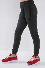 Pantalon de jogging garçon Tommylife en gros, couleur anthracite chiné, avec poches zippées, coupe standard et ourlets resserrés - 64042