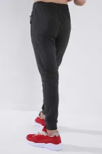 Pantalon de jogging garçon Tommylife en gros, couleur anthracite chiné, avec poches zippées, coupe standard et ourlets resserrés - 64042