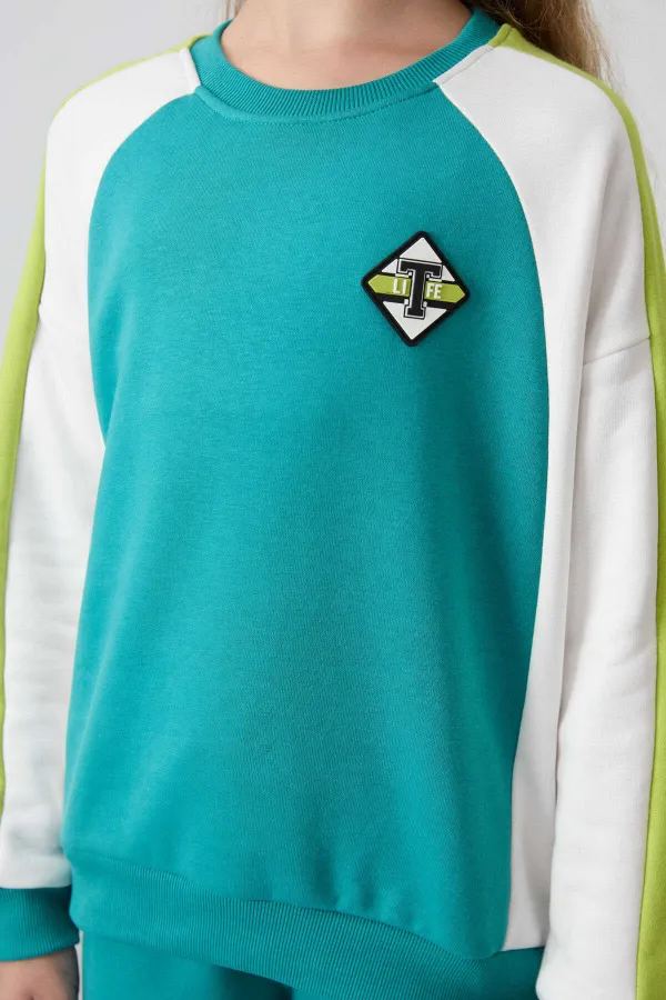 Ensemble de survêtement Tommylife Wholesale pour filles de 7 à 15 ans, col rond, coupe standard, réf. 75165, bleu marine et vert.