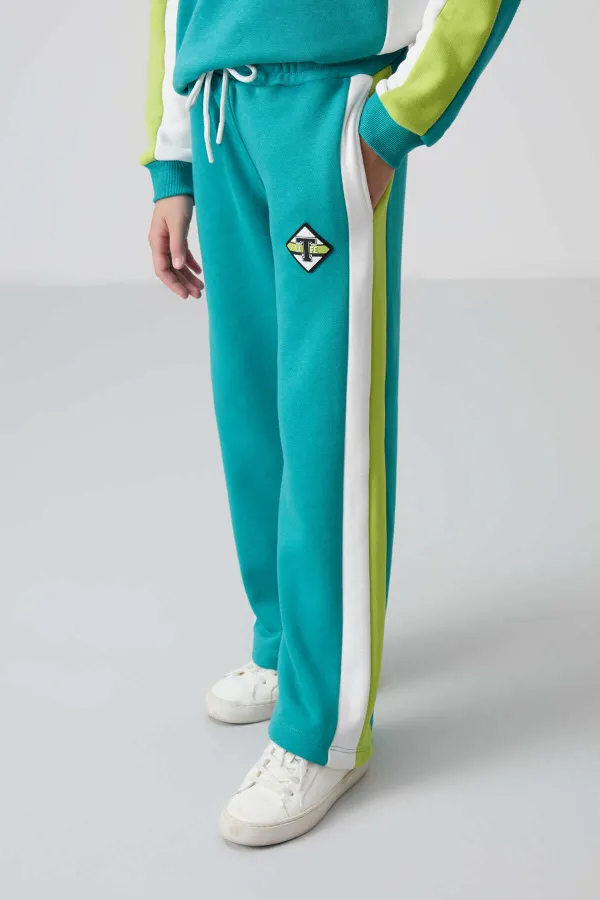 Ensemble de survêtement Tommylife Wholesale pour filles de 7 à 15 ans, col rond, coupe standard, réf. 75165, bleu marine et vert.
