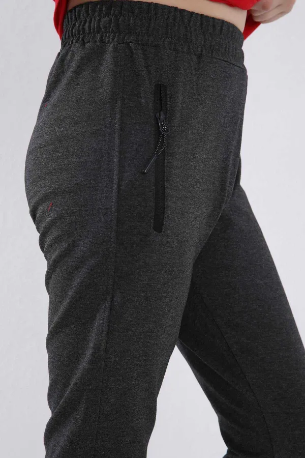 Pantalon de jogging garçon Tommylife en gros, couleur anthracite chiné, avec poches zippées, coupe standard et ourlets resserrés - 64042
