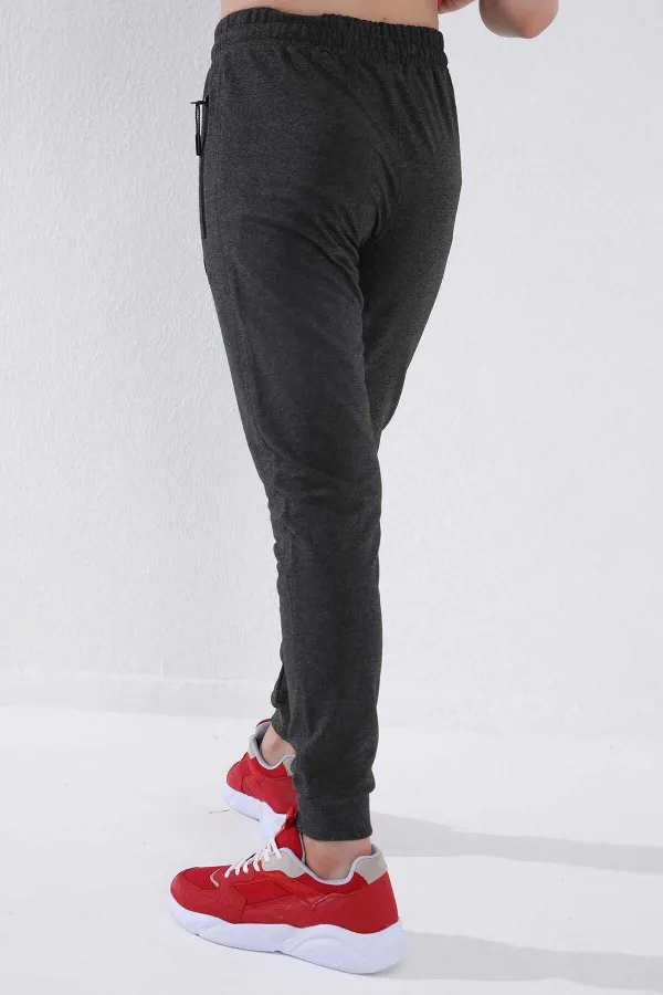 Pantalon de jogging garçon Tommylife en gros, couleur anthracite chiné, avec poches zippées, coupe standard et ourlets resserrés - 64042