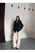 VESTE AVEC CEINTURE D'ÉPAULE ET MANCHES TOMBASES